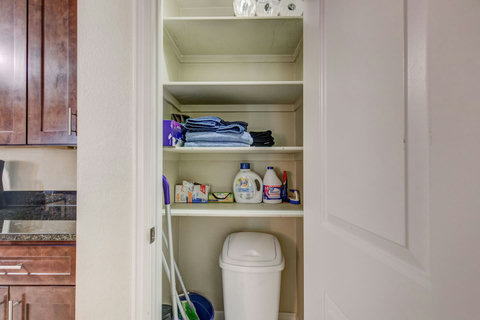 Storage closet between the kitchen and bathroom