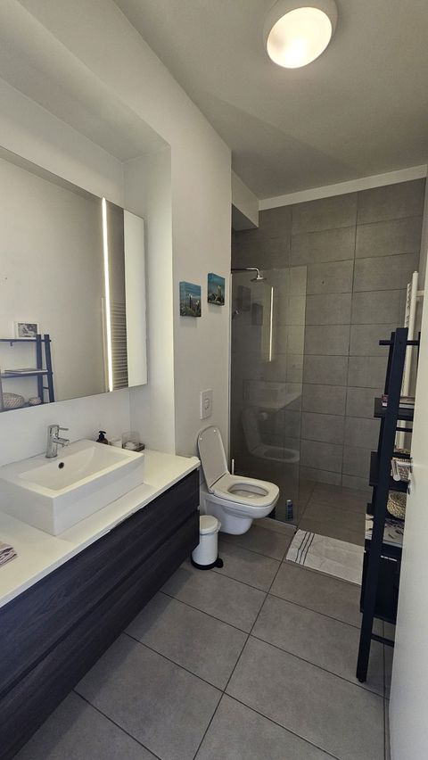 The bathroom is clean, spacious and modern.