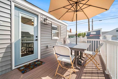 Outdoor dining area on side deck with seating for 8 people around Polywood table. 