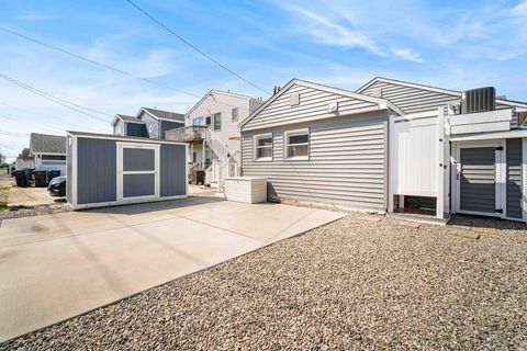 Two storage sheds stocked with beach supplies and brand new outside shower. 