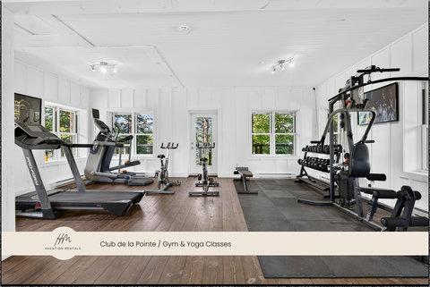 Bright on-site gym with cardio machines, weights, and workout space