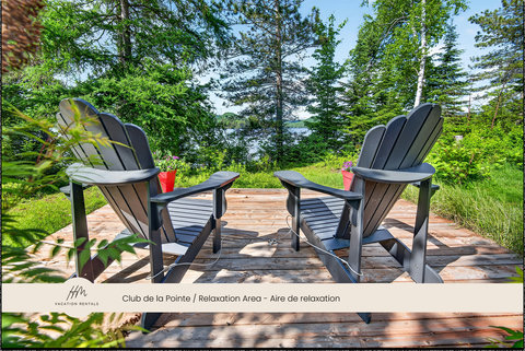 Private forest deck with Adirondack chairs and serene water views