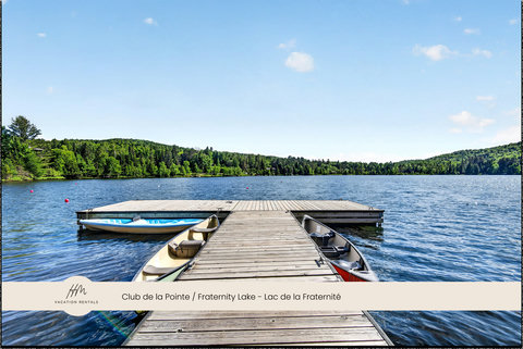 Private lakeside dock with canoes and serene forest views