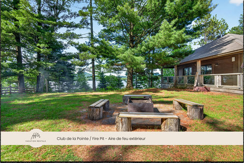 Rustic fire pit retreat with cabin deck and tranquil lake views
