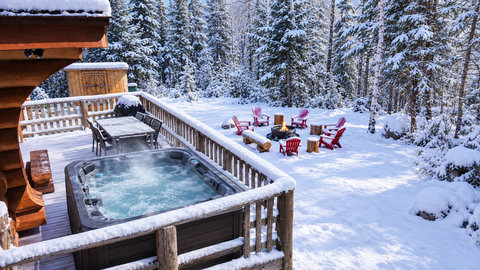 Private hot tub, fire pit, and forest views in a snowy winter escape