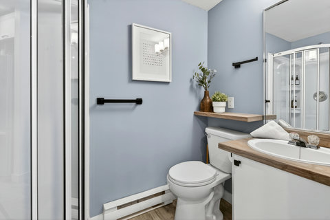 Bright modern bathroom with glass shower and stylish vanity