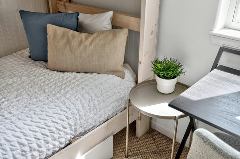 Cozy bed nook with natural light and a handy workspace