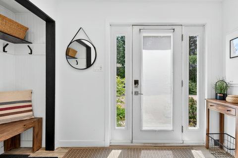 Bright, stylish entryway with natural light and guest-friendly storage