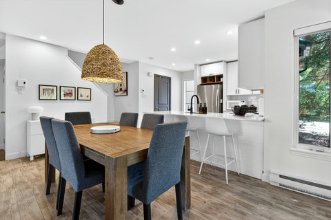 Bright open dining area with modern kitchen and stylish breakfast bar