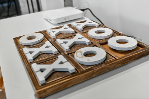 Chic wooden tic-tac-toe game for a fun, welcoming touch
