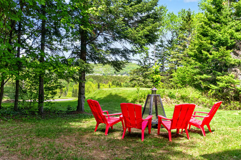 Relax by the fire pit in a private, tree-lined outdoor retreat