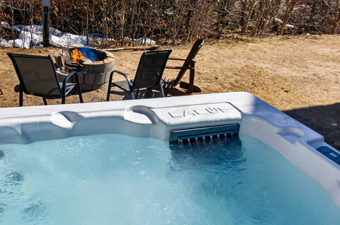 Private hot tub and fire pit lounge for cozy, year‑round relaxation