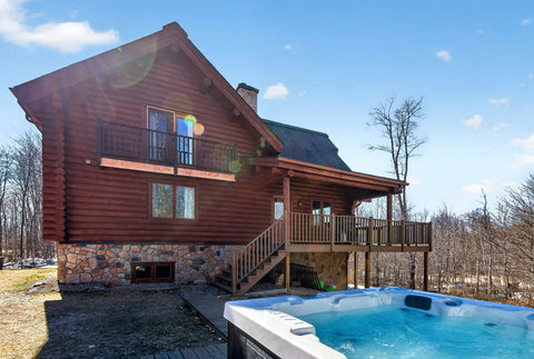 Cozy log cabin retreat with deck, balcony, and private hot tub