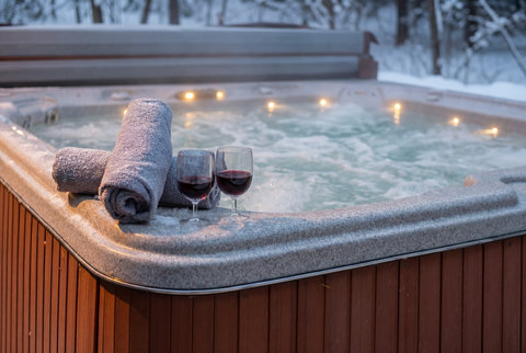 Private hot tub with snowy views, soft lights, and wine-ready relaxation