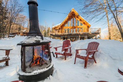 Cozy winter cabin with outdoor fire pit and scenic wraparound deck