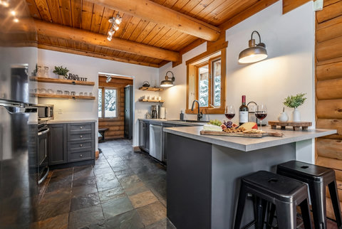 Rustic-modern kitchen with island seating and warm cabin charm