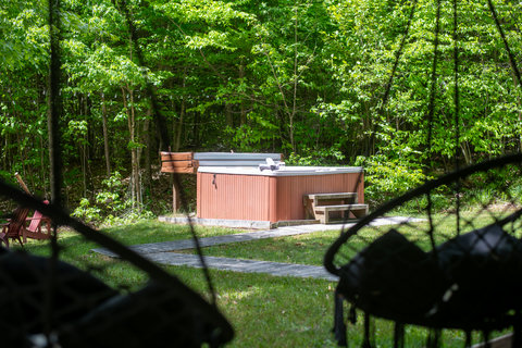 Private hot tub nestled in a peaceful, wooded backyard retreat