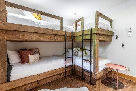 Custom rustic bunk room with cozy beds for families and groups