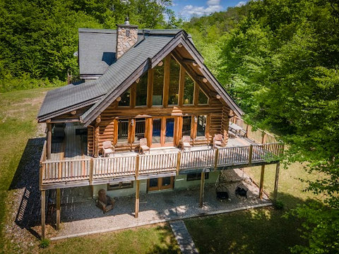 Secluded log cabin with wraparound deck, huge windows and firepit patio