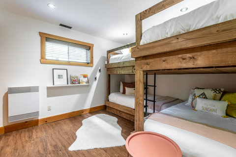Cozy rustic bunk room with multiple beds—perfect for families or groups
