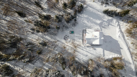 Secluded snowy cabin retreat with forest views and outdoor fire pit