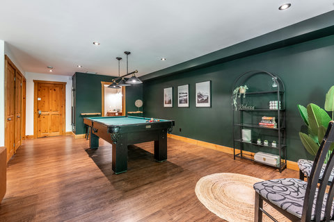 Inviting game room with pool table, stylish décor, and cozy lounge seating