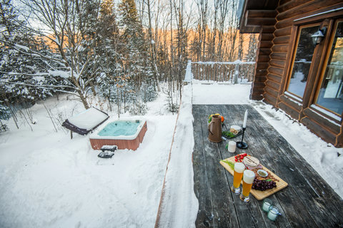 Private hot tub, snowy forest views, and cozy cabin deck vibes