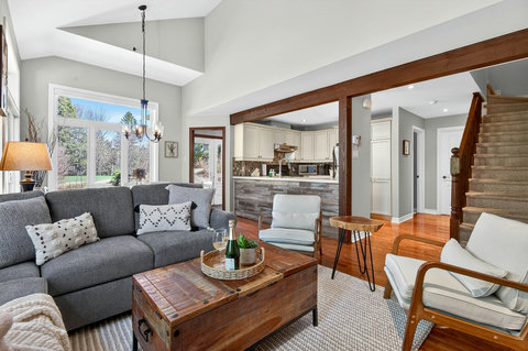 Bright open living with vaulted ceilings, cozy seating, and a chic breakfast bar.