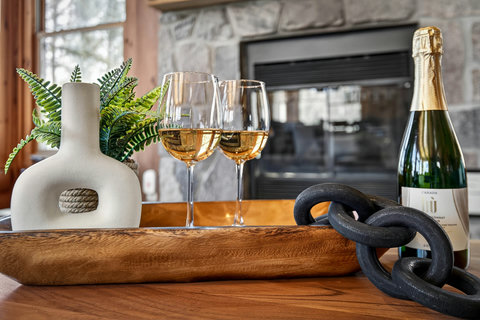 Sip champagne by the fireplace in this warm, stylish retreat.