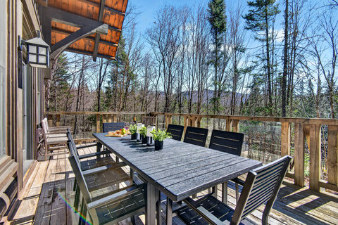 Spacious forest-view deck with dining for 8—perfect for alfresco meals.