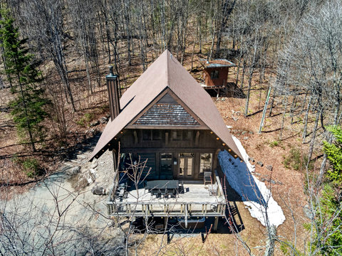 Secluded creekside cabin with spacious deck, tucked in a serene forest.