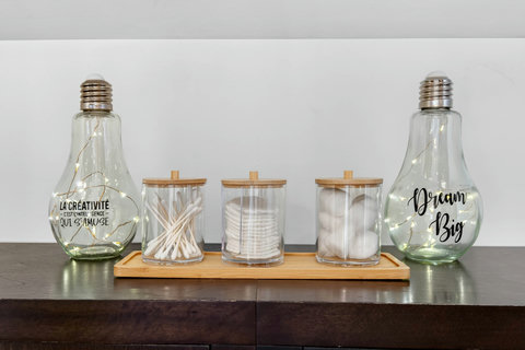 Spa-like vanity with cotton essentials, bamboo accents, and cozy fairy lights.