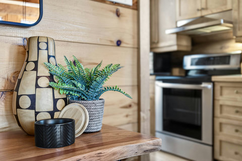 Warm cabin kitchen with stainless appliances and chic nature-inspired decor