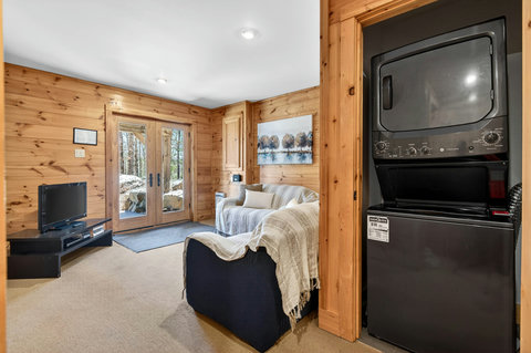 Cozy wood-paneled lounge with patio doors & in-unit laundry