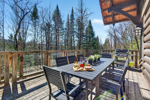 Forest-view deck with dining for 8 and a gas grill—perfect alfresco.