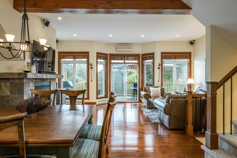 Main floor view with dining room, living room and Fireplace with TV