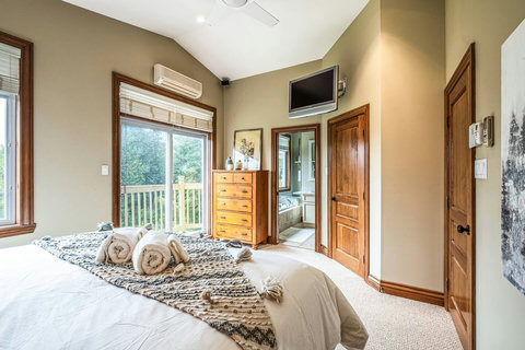 Master bedroom with TV, patio and private full bathroom