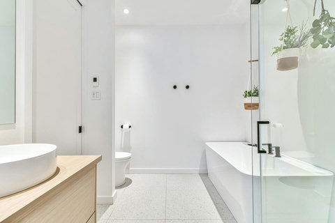 Refresh and relax in a bright ensuite with soaking tub, rainfall shower, and elegant finishes.