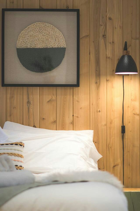 Scandinavian simplicity meets cozy comfort in the primary suite.