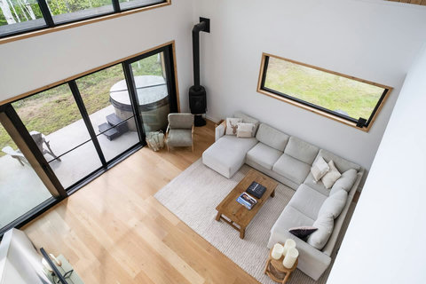 Soak in the hot tub or relax fireside in this bright, modern chalet with soaring windows and forest views.