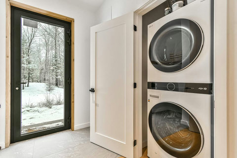 Convenient laundry closet with full-size washer and dryer, just off the kitchen.