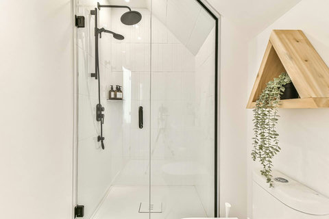 Bathroom 2 – A bright upstairs full bath with rain shower and modern single vanity.