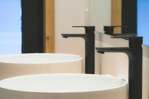 Modern black fixtures and clean lines elevate this private ensuite into a spa-like escape.