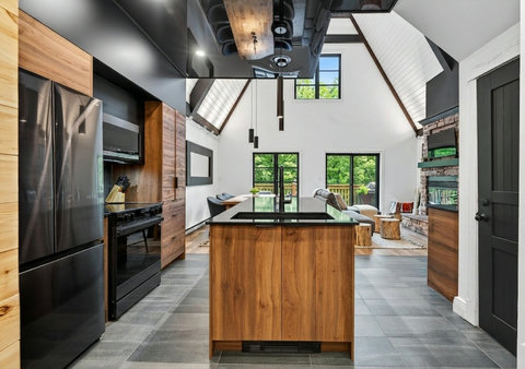 Vaulted great room with designer kitchen, island, and stunning stone fireplace