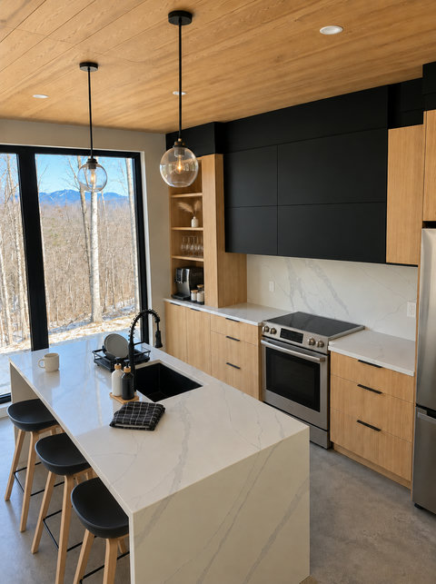 Modern designer kitchen with waterfall island and stunning mountain views