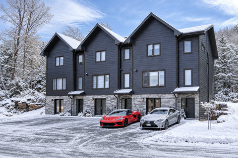 Modern snowy townhouse retreat with stylish curb appeal and easy parking