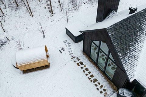Snowy A-frame escape with hot tub, sauna, and forest privacy