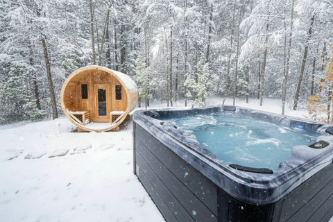 Snowy forest hot tub and barrel sauna for the ultimate cozy retreat
