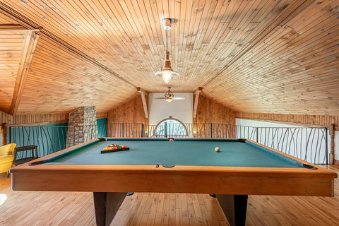 Wooden Mezzanine back view on pool table and cathedral roof