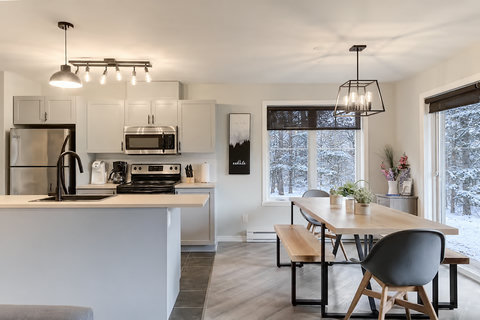 Bright modern kitchen & dining with snowy woodland views